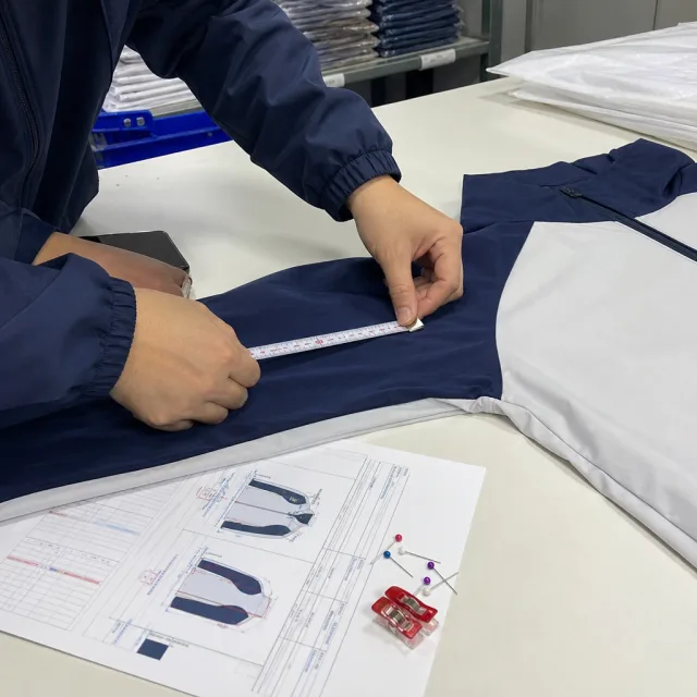 Sample garment being measured against the tech pack before bulk
